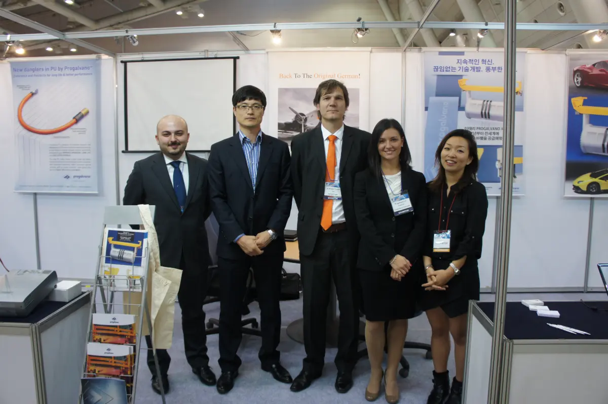 Five people standing together at a trade fair booth